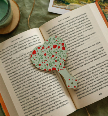 image of a green bookmark with a red rose pattern